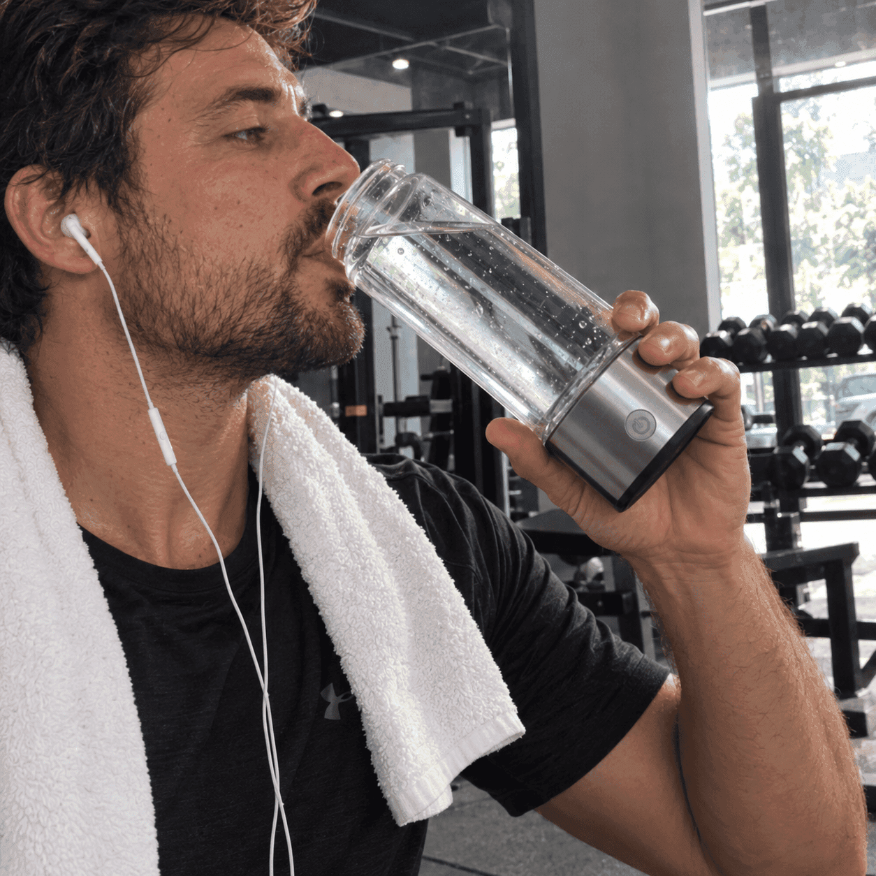 Person using AquaFusion hydrogen water bottle during workout
